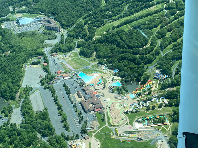 Indoor and Outdoor water park resorts in the center of the picture. Indoor water park in the left upper corner. Outdoor Water park at the right bottom corner.